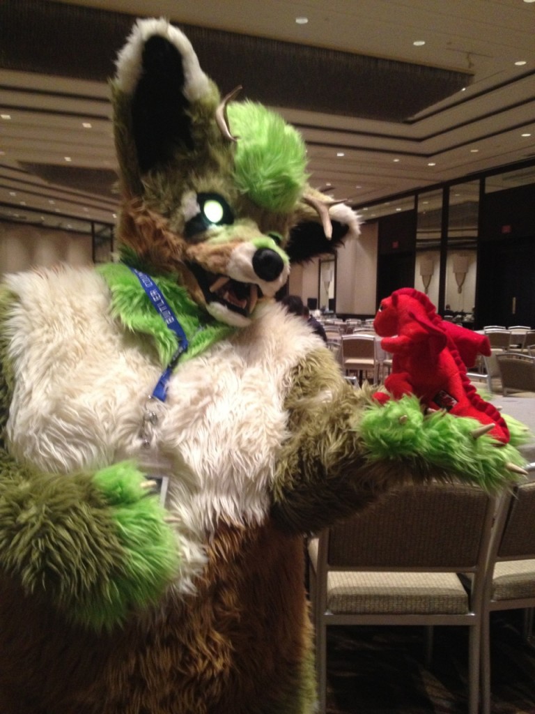 Dafydd with Aizui, a glowy-eyed green tanuki-ish thing. This is fairly normal for AnthroCon.